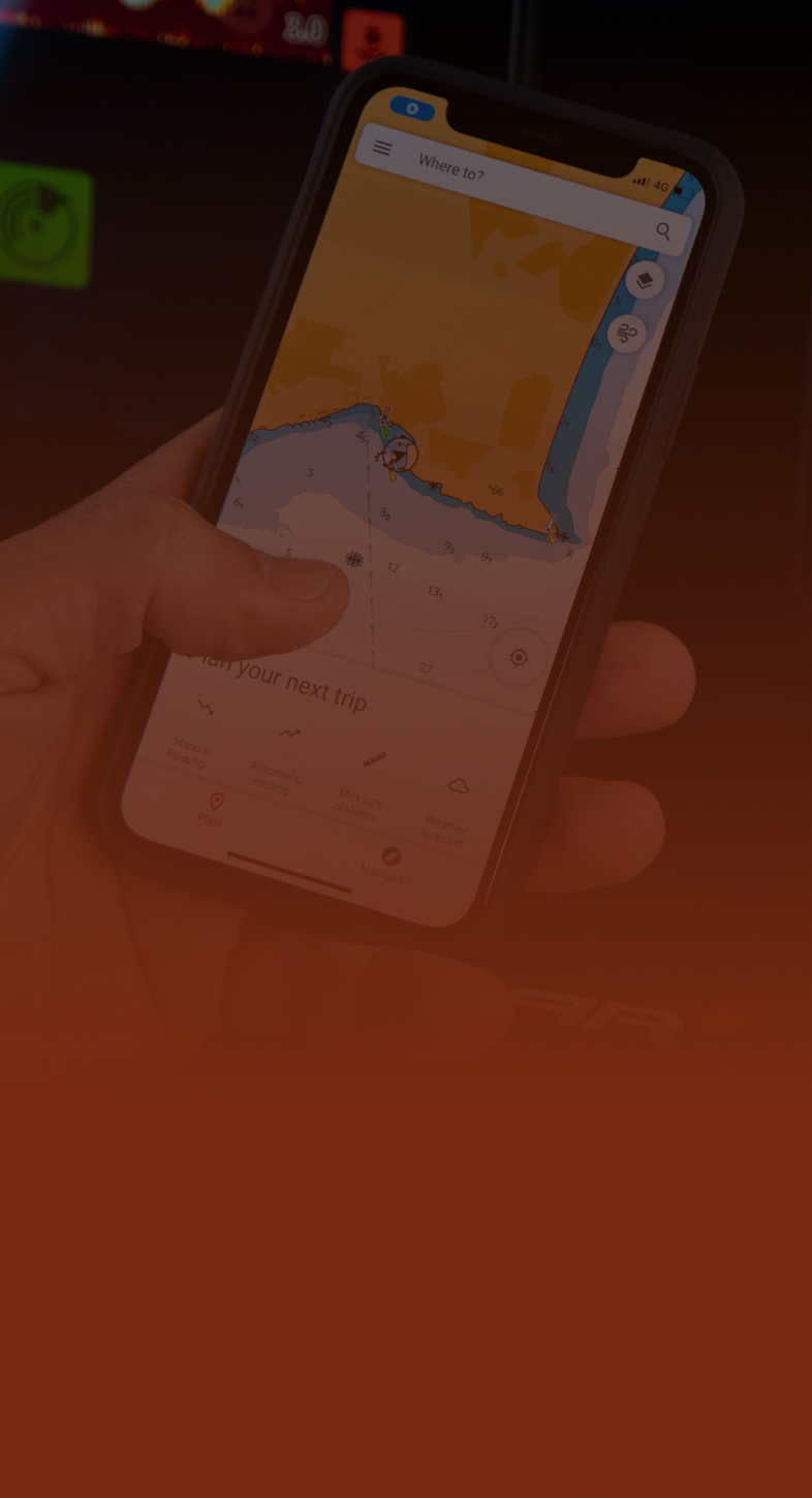 A person using CMAP® marine charts.